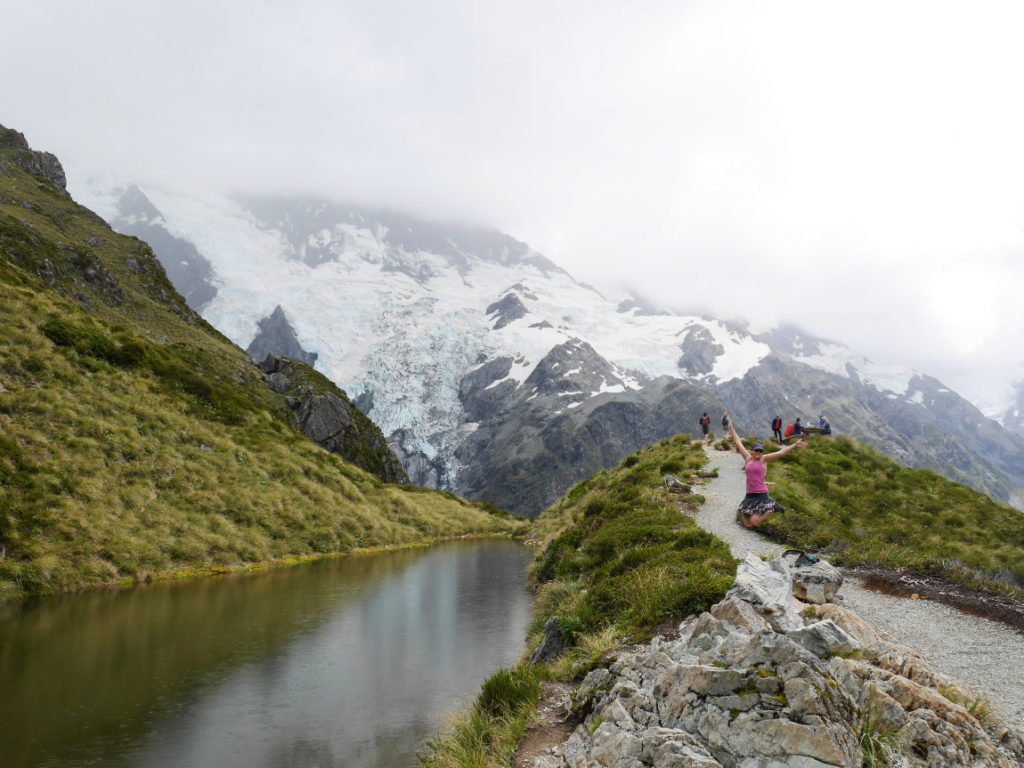 Jumping in front of the Sealy Tarns and Mt Sefton