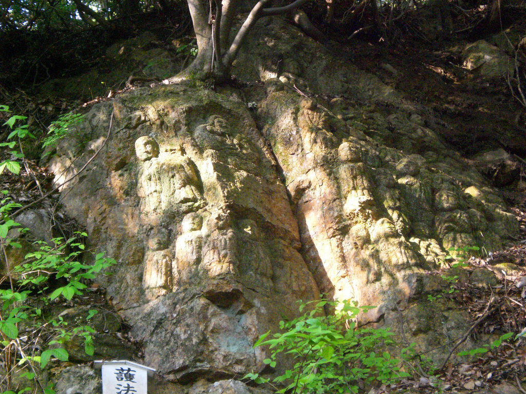 Ancient stone statues carved into the hillside