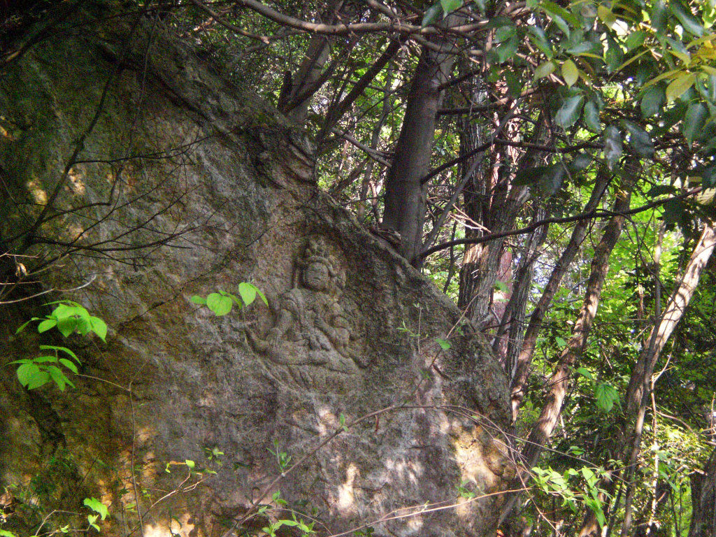 Ancient stone statues carved into the hillside