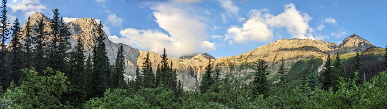 Early morning glow on Limetone Peak, Helmet Mountain and Sharp Mountain towering above Helmet Falls